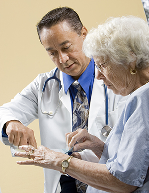 Health care provider talking to patient in exam room.